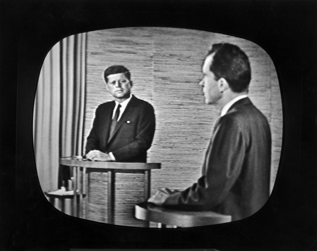 Presidential candidate Richard M. Nixon (right) speaks during a televised debate while opponent John F. Kennedy watches, 1960.