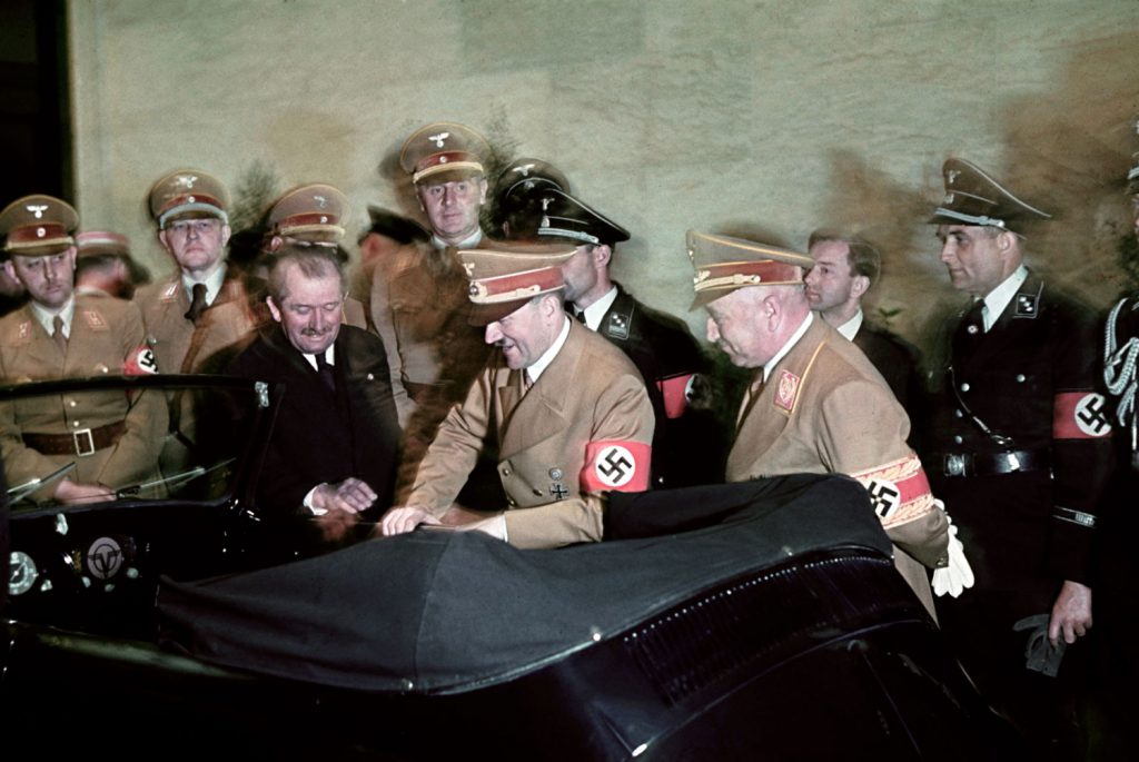 The automobile engineer and designer Ferdinand Porsche (in suit) presents Hitler with a convertible Volkswagen for Hitler's 50th birthday, Berlin, Germany, April 20, 1939.